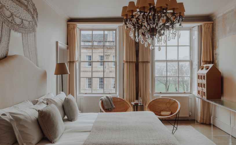 Hotel bedroom with dollhouse and chandelier